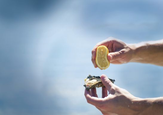 Lemon squeezed on a freshly shucked oyster harvested in Port Stephens