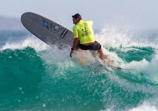 Surfer carves up a wave at the Australian Longboard Surfing Open in Kingscliff.
