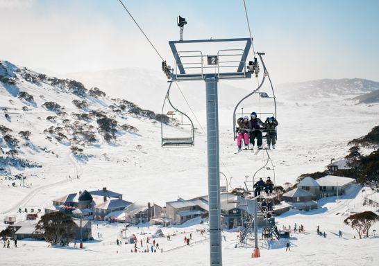 Skiiers riding the chair lifts at Charlotte Pass Ski Resort in the Snowy Mountains