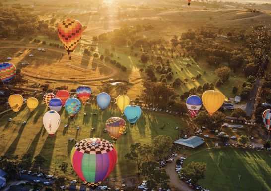 Hot air balloons launching over the town at sunrise during the Canowindra Balloon Challenge, Canowindra - Credit: Noel Butcher