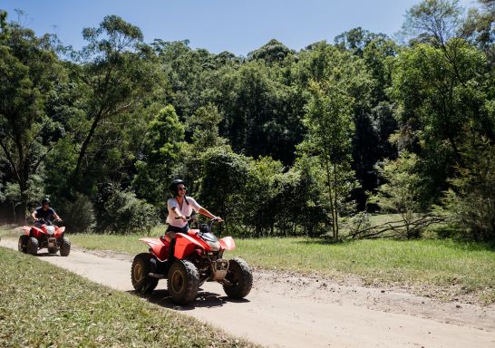 Friends enjoying a guided tour on quad bikes at Glenworth Valley in the Central Coast.