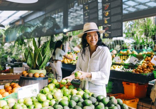 Woman purchasing fresh produce from Tropical Fruit World, Duranbah