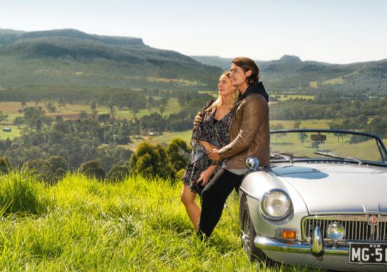 Self-driving couple enjoying scenic views across Kangaroo Valley, South Coast