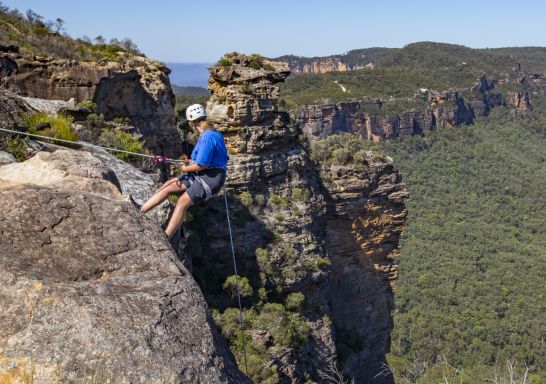 Woman abseiling at Cahills Lookout, Katoomba in the Blue Mountains