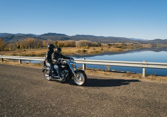 Motorcyclist stopping for a scenic break besides Khancoban Pondage in the Snowy Mountains