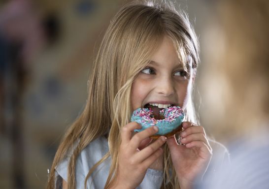 Child enjoying a donut at The Newport, Newport, Sydney