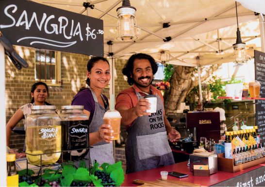 Stall owners with beverages at The Rocks Friday Foodie Market