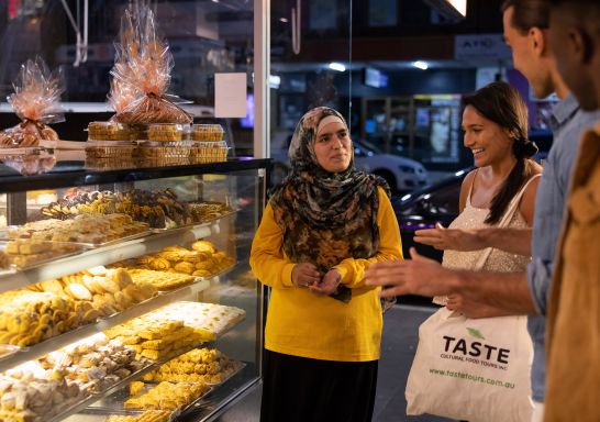 Friends browsing the sweets on display at Asal Sweets, Merrylands