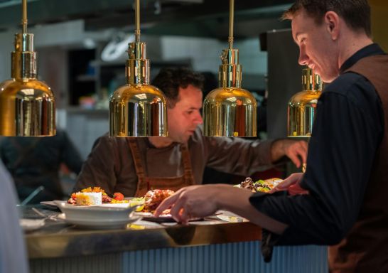 Chefs lining up plates of dishes, Tattersalls Restaurant and Pizza Garden, Armidale - Credit: Tattersalls Hotel