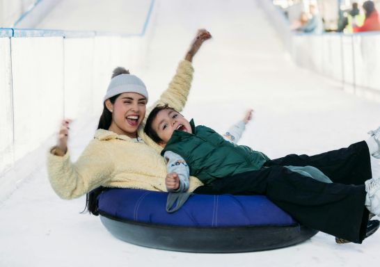 Family on a donut sled, Snow Time in the Garden, Pokolbin - Credit: Snow Time in the Garden